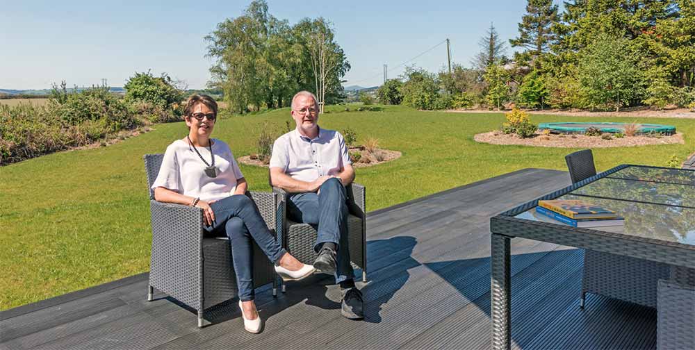 Homeowners Aine & Frank Dowd relaxing in their garden.