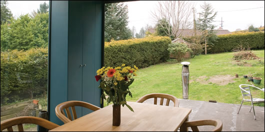 On the upper floor the rear wall is a fully-glazed door system, facing south-west onto the garden, to take full advantage of passive solar heat and light
